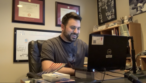 Blanchet working on his computer in his at home office space.