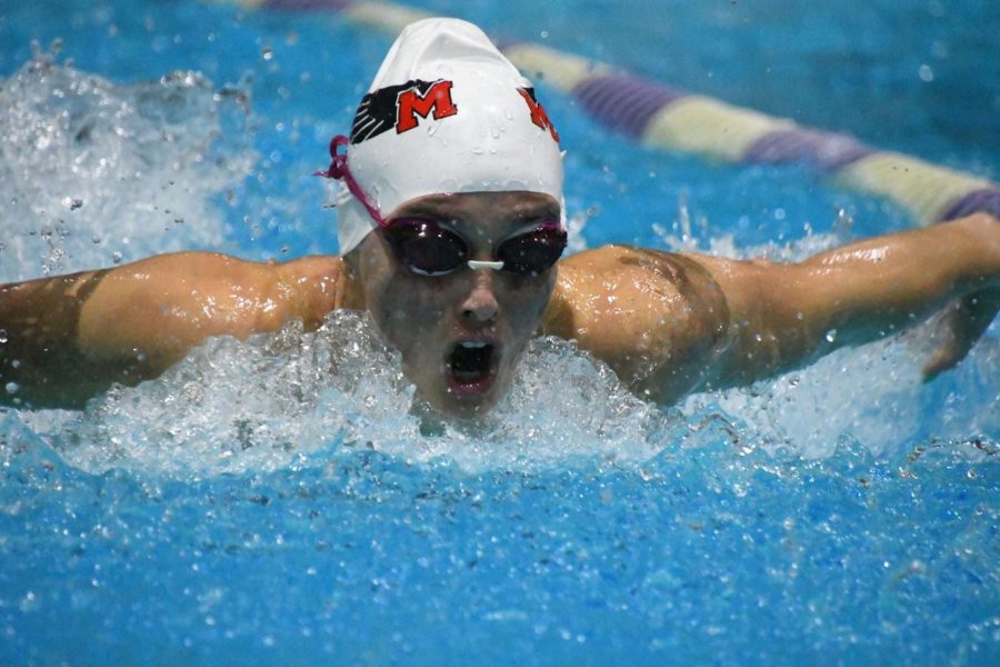Sophia Brown (23) swims butterfly in a swim meet last season.
