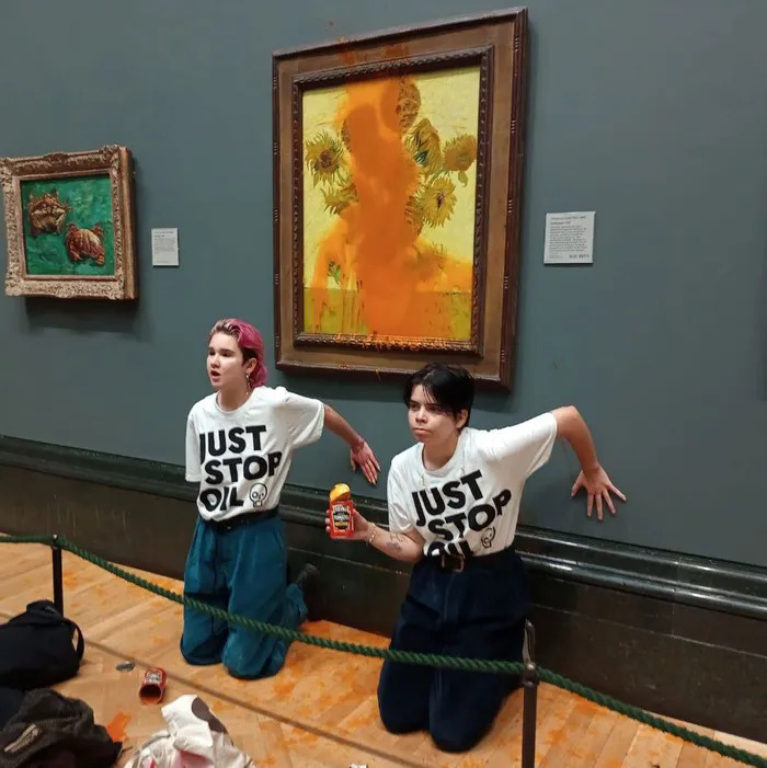 Phoebe Plummer and Anna Holland protest at Van Goghs Sunflowers in Londons National Art Gallery.